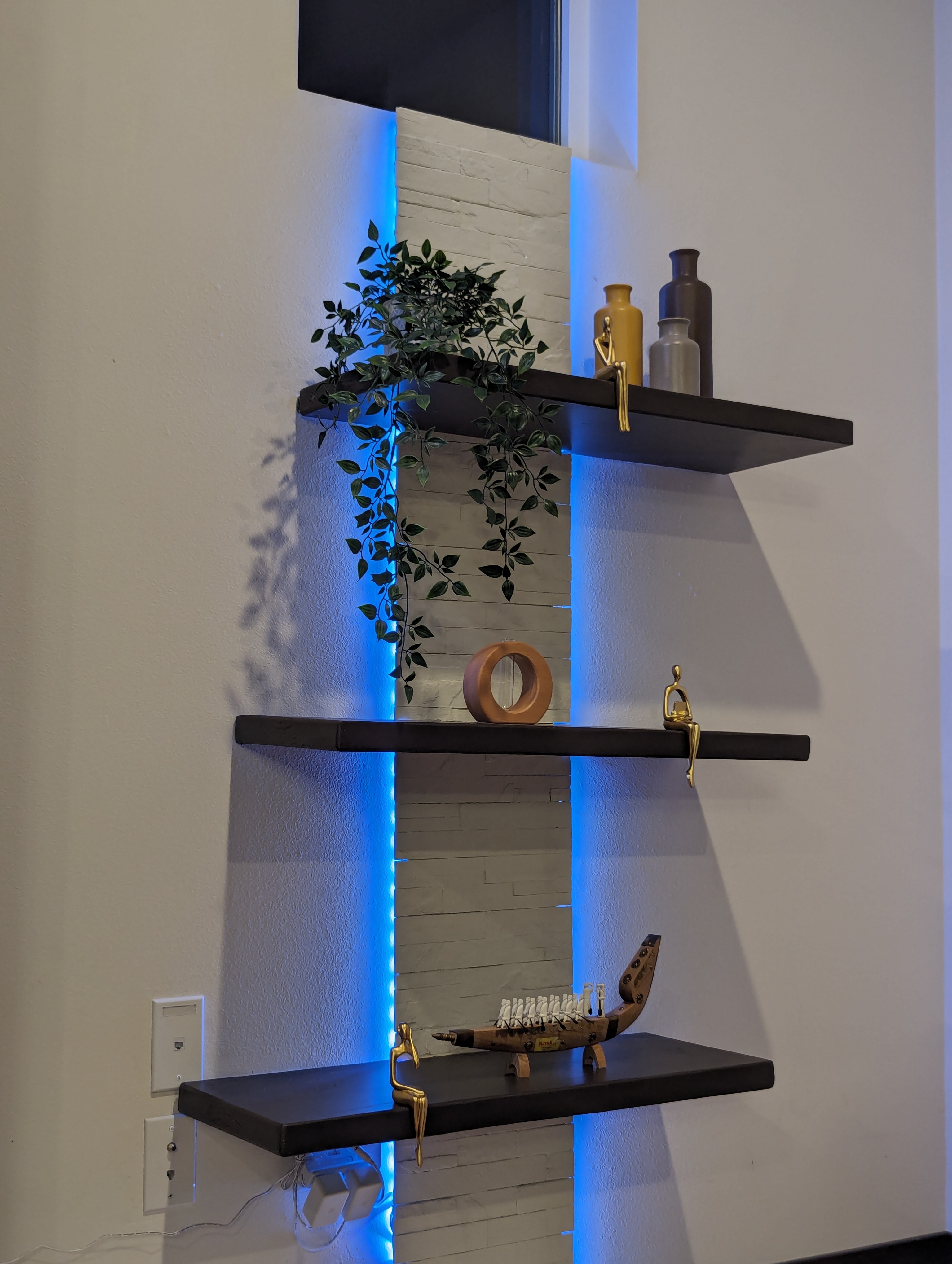 Floating shelves with integrated smart lighting accentuating the décor